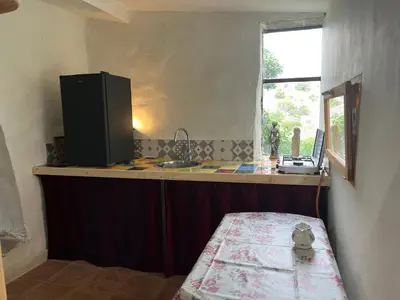 a kitchen with a counter with a sink and a window at Chateau Fitou Presbytery in Fitou