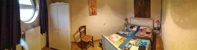 a small bedroom with a bed and a chair at Gîte de la Truie qui File in Noailhac