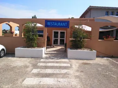 a building with a sign in front of it at Hôtel Le Floreal in Trèbes