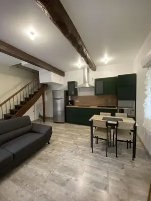 a living room with a couch and a table at Agréable maison dans petit village calme in Floure