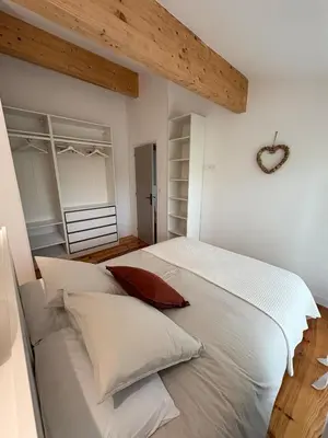 a large living room with stairs and a kitchen at Appartement Loft in Mirepoix