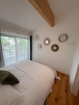 a bedroom with two beds with white sheets at Appartement Loft in Mirepoix