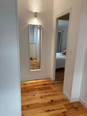 a hallway with a mirror and a bed in a room at Appartement Loft in Mirepoix