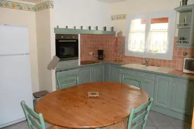 a kitchen with a wooden table in a kitchen at Gîte 8 Personnes Piscine Privée Aude Occitanie Sud Corbières in Fabrezan