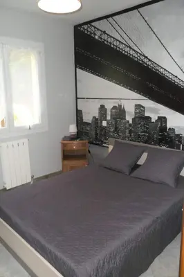 a bedroom with a bed with a view of the city at Gîte 8 Personnes Piscine Privée Aude Occitanie Sud Corbières in Fabrezan