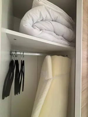 a closet filled with white towels and a pillow at Chez Cricri, modern accommodation in Bizanet