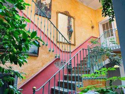 a staircase in a home with a painting on the wall at Appartement avec jardin sous les couverts in Mirepoix