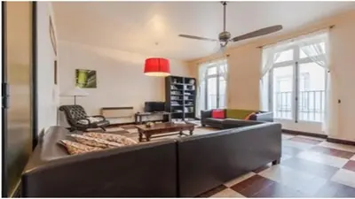 a living room with a large couch and a table at Chez Georges in Carcassonne