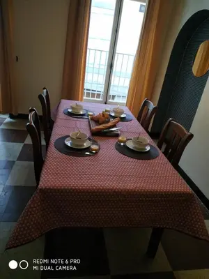 a table with a red table cloth on it with food on it at Chez Georges in Carcassonne