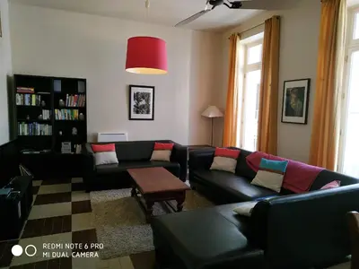 a living room with a couch and a table at Chez Georges in Carcassonne