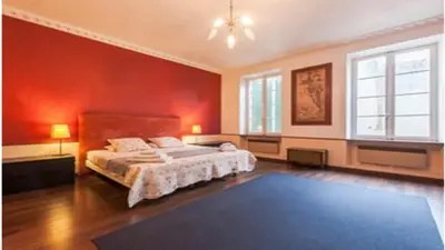 a bedroom with a bed and a red wall at Chez Georges in Carcassonne