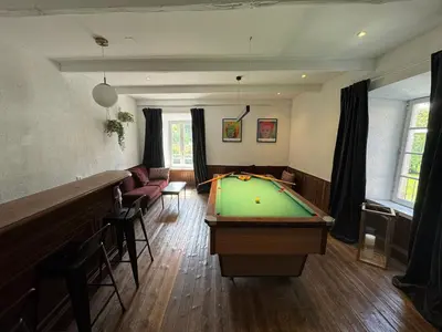 a living room with a pool table in it at Magnifique Gîte 4 à 10 personnes in Nages
