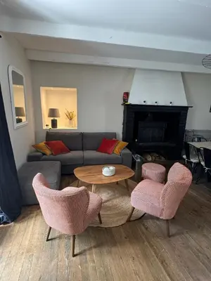 a living room with a couch and a table and chairs at Magnifique Gîte 4 à 10 personnes in Nages