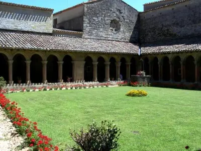 a large building with a green yard with flowers at Charming farmhouse gite in southwestern France in Montferrand