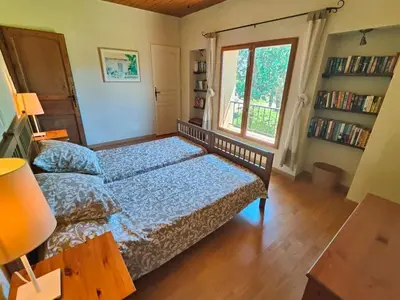 a bedroom with a bed and a window at Charming farmhouse gite in southwestern France in Montferrand