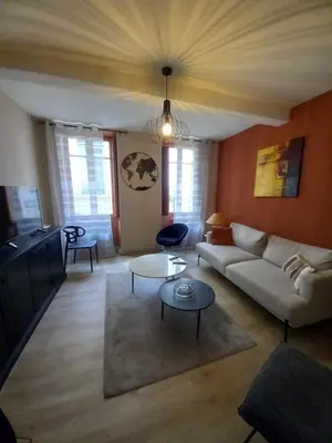 a living room with a couch and a tv at Maison du coutelier in Carcassonne
