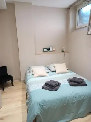 a bedroom with a bed with two towels on it at Maison du coutelier in Carcassonne
