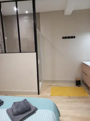 a bedroom with a bed and a sliding glass door at Maison du coutelier in Carcassonne