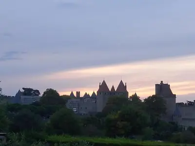 a view of a castle at sunset at Maison du coutelier in Carcassonne