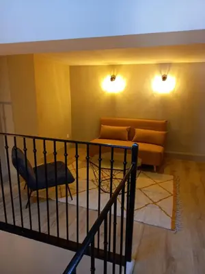 a living room with a couch and a chair at Maison du coutelier in Carcassonne