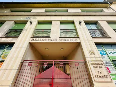 a building with a red gate in front of it at T2 à proximité Grand Buffets in Narbonne