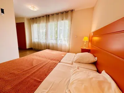 a bedroom with a large bed and a window at T2 à proximité Grand Buffets in Narbonne