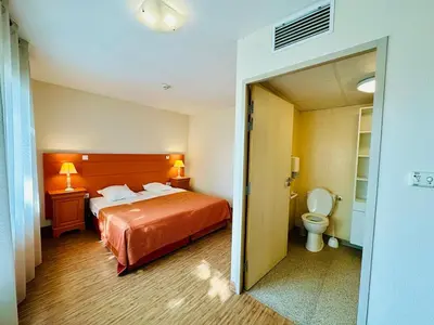 a hotel room with a bed and a toilet at T2 à proximité Grand Buffets in Narbonne