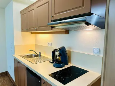 a kitchen with a sink and a mixer on a counter at T2 à proximité Grand Buffets in Narbonne