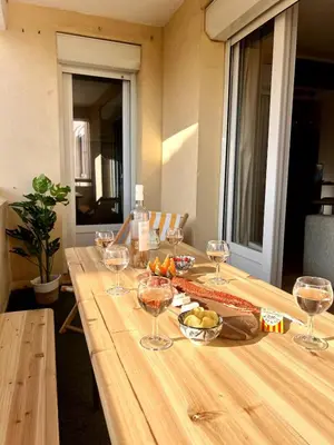 a long wooden table with wine glasses on it at Plage à 15 min - Proche de la Gare - 6 personnes - 3 Chambres - Idéal Famille in Narbonne