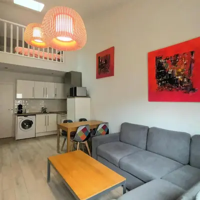a living room with a couch and a table at Pipa in Narbonne