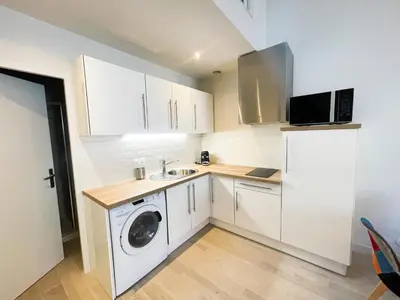 a kitchen with a washing machine and a refrigerator at Pipa in Narbonne
