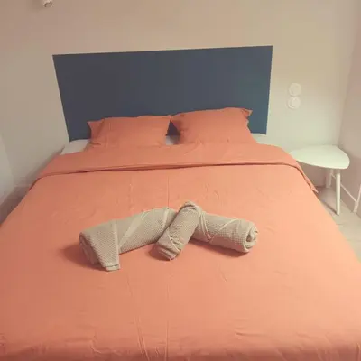 a bed with a pair of shoes laying on it at Pipa in Narbonne