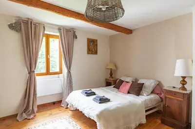 a bedroom with a bed and a window at La Campagnarde - Avec jardin clos in Campagne-sur-Aude