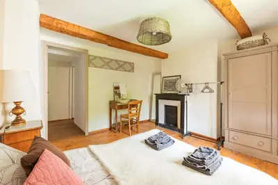 a living room with a couch and a fireplace at La Campagnarde - Avec jardin clos in Campagne-sur-Aude