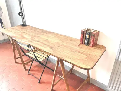 a wooden desk with books on it with a chair at Le PALACE, Auberge in Carcassonne