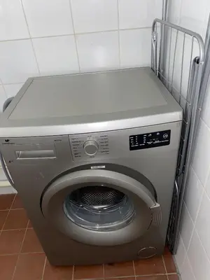 a washing machine sitting in a corner of a room at Le PALACE, Auberge in Carcassonne