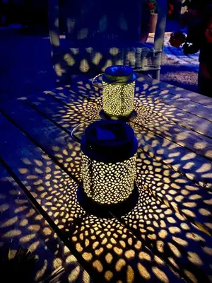 a table with two lights on top of it at Les gites du tilleul in Villefranche-de-Lauragais