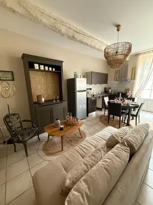 a living room with a couch and a table at Les gites du tilleul in Villefranche-de-Lauragais
