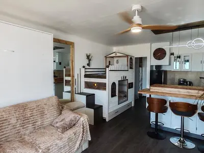 a living room with a couch and a fireplace at Studio SAM - Face à la Mer in Port-la-Nouvelle
