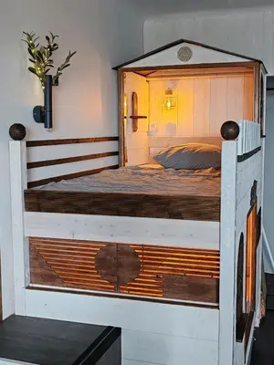 a bedroom with a large wooden bed in a room at Studio SAM - Face à la Mer in Port-la-Nouvelle