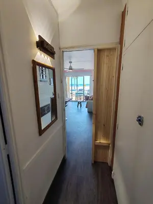 a hallway with a room with a door and a mirror at Studio SAM - Face à la Mer in Port-la-Nouvelle