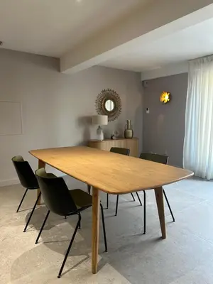 a large wooden table in a room with chairs at La remise d'Edouard in Saint-Papoul