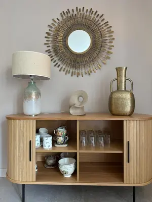 a wooden cabinet with a lamp and a mirror at La remise d'Edouard in Saint-Papoul