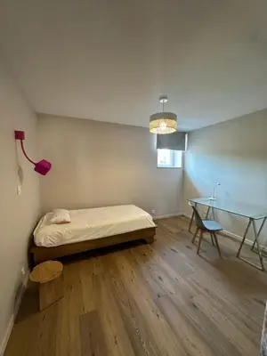a bedroom with a bed and a glass table at La remise d'Edouard in Saint-Papoul