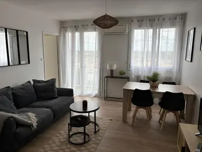 a living room with a couch and a table at La Sentinelle - Vue Cité in Carcassonne