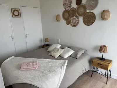 a bedroom with a bed with towels on it at La Sentinelle - Vue Cité in Carcassonne