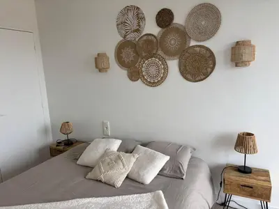 a bedroom with a bed with plates on the wall at La Sentinelle - Vue Cité in Carcassonne