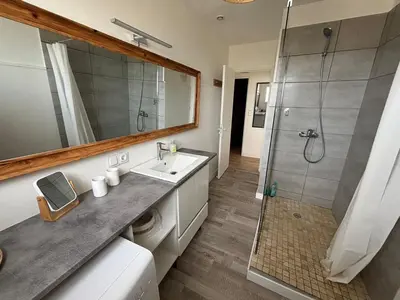 a bathroom with a sink and a shower at La Sentinelle - Vue Cité in Carcassonne