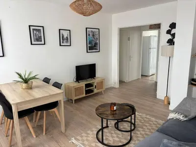 a living room with a couch and a table at La Sentinelle - Vue Cité in Carcassonne
