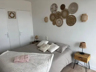 a bedroom with a bed and some plates on the wall at La Sentinelle - Vue Cité in Carcassonne